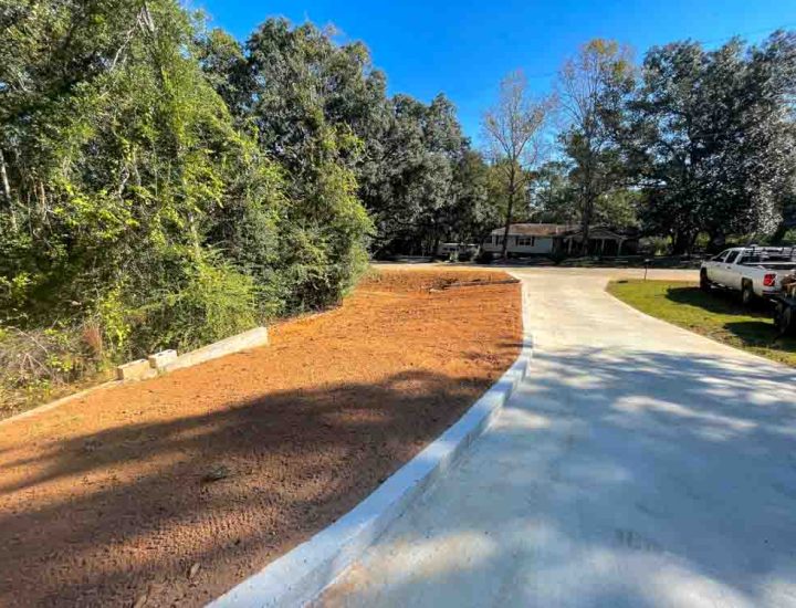 A driveway, transformed by concrete resurfacing, now boasts a sleek and renewed surface, radiating a sense of modernity and durability