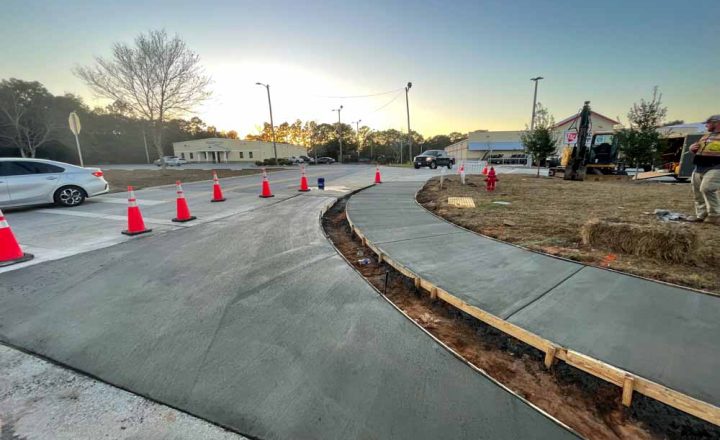 Ongoing Concrete Walkway Construction with traffic cones marking the area with wet cement