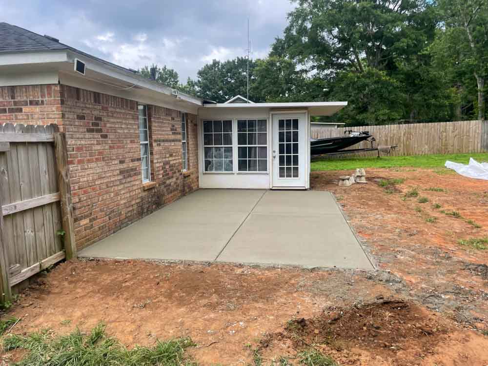 Concrete Patio Construction on a backyard of a brick house